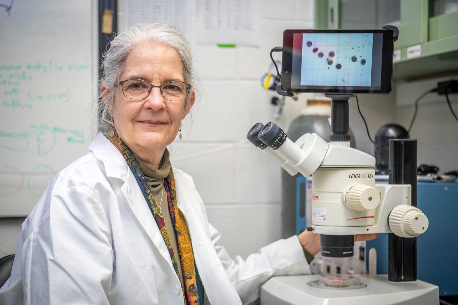 Carol Keefer portrait at microscope